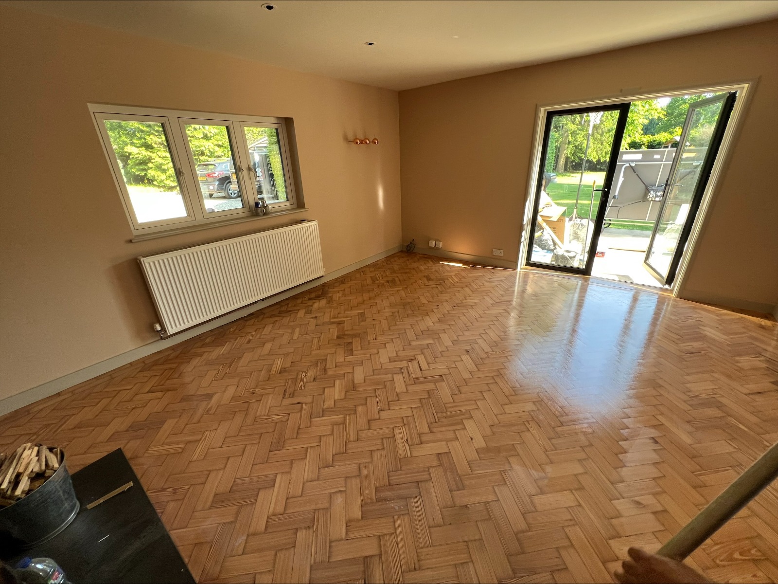 Floor Sanding Preparation Checklist shown on a freshly restored oak herringbone parquet living room floor, fully cleared and ready after sanding and refinishing.